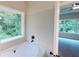 Relaxing soaking tub with a view to a lush garden view at 504 Iris Way, Villa Rica, GA 30180