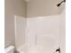 Bathroom showcasing a tub with a shower head, white walls, and fixtures creating a clean and functional space at 504 Iris Way, Villa Rica, GA 30180