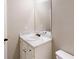 Bathroom features a vanity with storage, a marble countertop, a sink, a mirror, and a toilet at 504 Iris Way, Villa Rica, GA 30180