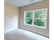Bright bedroom boasts a large window with natural green, wooded views at 504 Iris Way, Villa Rica, GA 30180