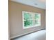 Bedroom featuring a large window with a view of lush greenery, offering natural light and serene ambiance at 504 Iris Way, Villa Rica, GA 30180