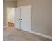 Bedroom with carpet, neutral walls, and double doors, providing a cozy and inviting space at 504 Iris Way, Villa Rica, GA 30180