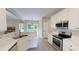 Bright kitchen boasts stainless steel appliances, white cabinets, and marble countertops at 504 Iris Way, Villa Rica, GA 30180