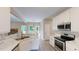 Modern kitchen with white cabinets, stainless steel appliances, laminate floors and marble countertop at 504 Iris Way, Villa Rica, GA 30180