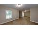 Spacious living room features hardwood floors, a window, and neutral paint, creating a bright and inviting atmosphere at 504 Iris Way, Villa Rica, GA 30180