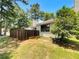 Backyard featuring a grassy area with plants and trees, along with a wood fence for privacy at 1152 Country Ct, Lawrenceville, GA 30044