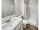 Bright bathroom featuring a sleek vanity, modern faucet, and a shower with a white surround at 1152 Country Ct, Lawrenceville, GA 30044