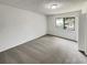 Spacious bedroom featuring neutral carpet, a window for natural light, and ample closet space at 1152 Country Ct, Lawrenceville, GA 30044