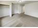Large bedroom with neutral carpet, a walk-in closet, and multiple doors enhancing accessibility at 1152 Country Ct, Lawrenceville, GA 30044