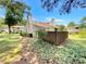Exterior view of the two-story home featuring a backyard with trees, plants, and wood fencing at 1152 Country Ct, Lawrenceville, GA 30044