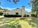 Rear exterior view featuring a well-maintained lawn and mature trees, providing privacy and a serene atmosphere at 1152 Country Ct, Lawrenceville, GA 30044
