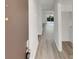 Hallway featuring neutral color palette, vinyl floors, and access to a room with sliding glass doors at 1152 Country Ct, Lawrenceville, GA 30044