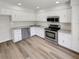 Modern kitchen featuring white cabinets, stainless steel appliances, and granite countertops at 1152 Country Ct, Lawrenceville, GA 30044