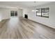 Bright living room with wood flooring, modern lighting fixture, and sliding door to outdoor patio at 1152 Country Ct, Lawrenceville, GA 30044