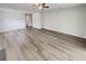 Spacious open-concept living area featuring wood floors, a ceiling fan and modern lighting at 1152 Country Ct, Lawrenceville, GA 30044