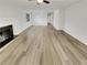 Open-concept living room with wood-look flooring and a cozy fireplace, perfect for gatherings and relaxation at 1152 Country Ct, Lawrenceville, GA 30044