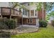 Backyard with a stone patio beneath the wooden deck and lots of green space at 1416 Vernon Ridge Close, Dunwoody, GA 30338