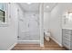 Bathroom featuring glass-enclosed shower with seat, modern vanity and wood look flooring at 1416 Vernon Ridge Close, Dunwoody, GA 30338
