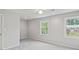 This bedroom features two windows, carpet, ceiling fan, and neutral paint at 1416 Vernon Ridge Close, Dunwoody, GA 30338