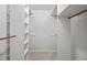 Walk-in closet with adjustable shelving and wooden closet rods at 1416 Vernon Ridge Close, Dunwoody, GA 30338