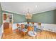 Dining room with hardwood floors, chandelier, and large windows provides an elegant setting for meals at 1416 Vernon Ridge Close, Dunwoody, GA 30338