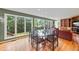 Bright dining room features large windows with green views, hardwood floors, and seating for six at 1416 Vernon Ridge Close, Dunwoody, GA 30338