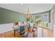 Elegant dining room with hardwood floors, chandelier, and large windows offers an inviting space at 1416 Vernon Ridge Close, Dunwoody, GA 30338