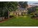 Charming two-story home with a manicured lawn and beautiful landscaping enhancing its curb appeal at 1416 Vernon Ridge Close, Dunwoody, GA 30338