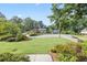 Wide angle view of several homes with manicured lawns, mature trees, and well-maintained landscaping at 1416 Vernon Ridge Close, Dunwoody, GA 30338