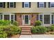 Close up of the front entrance featuring a brick surround, planters, and windows at 1416 Vernon Ridge Close, Dunwoody, GA 30338