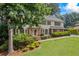Beautiful two-story home with manicured lawn, mature trees, and meticulously maintained landscaping at 1416 Vernon Ridge Close, Dunwoody, GA 30338
