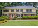 Inviting two-story home boasts a brick facade and beautifully landscaped front yard at 1416 Vernon Ridge Close, Dunwoody, GA 30338