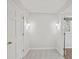 Hallway with neutral paint, plush carpet, and updated sconce lighting at 1416 Vernon Ridge Close, Dunwoody, GA 30338