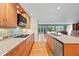 Open concept kitchen with custom wood cabinets, granite countertops, stainless steel appliances and recessed lights at 1416 Vernon Ridge Close, Dunwoody, GA 30338
