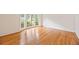 Bright living room with gleaming hardwood floors and large windows offers natural light at 1416 Vernon Ridge Close, Dunwoody, GA 30338