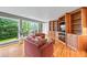 Bright living room features hardwood floors, large windows overlooking backyard, and custom built-ins at 1416 Vernon Ridge Close, Dunwoody, GA 30338