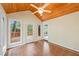 Charming sunroom with tile floor, wood-paneled ceiling, and multiple doors leading to the deck at 1416 Vernon Ridge Close, Dunwoody, GA 30338