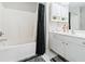 Bright bathroom with tub, white vanity, storage shelves, and decorative accents at 1968 Drennon Ave, Austell, GA 30106