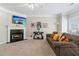 Cozy living room with a fireplace, mantle, and plush brown sofa with soft lighting at 1968 Drennon Ave, Austell, GA 30106