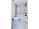 Modern bathroom with marble-style tile, a bathtub, and matte black hardware at 2027 Lois Pl, Atlanta, GA 30318