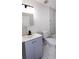 Modern bathroom featuring vanity with gray cabinets, sleek mirror and walk-in tub at 2027 Lois Pl, Atlanta, GA 30318
