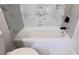 Close-up of a bathtub with a white marble surround and matte black hardware at 2027 Lois Pl, Atlanta, GA 30318