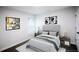 Cozy bedroom featuring neutral tones, decorative artwork, and two side tables at 2027 Lois Pl, Atlanta, GA 30318