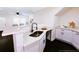 Modern kitchen featuring white cabinetry, sleek countertops, and updated appliances, perfect for cooking and entertaining at 2027 Lois Pl, Atlanta, GA 30318