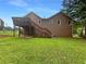 Back exterior showcasing a large wood deck overlooking a spacious, green lawn at 110 Silverthorne Dr, Douglasville, GA 30134