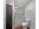 Bathroom featuring glass enclosed shower and a toilet, with dark accent wall at 110 Silverthorne Dr, Douglasville, GA 30134