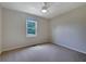 Carpeted bedroom features a ceiling fan and window views at 110 Silverthorne Dr, Douglasville, GA 30134