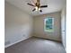 Bedroom showcasing neutral carpet, ceiling fan, and a window at 110 Silverthorne Dr, Douglasville, GA 30134
