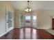 Bright dining room features hardwood floors, chandelier, and bay window overlooking the front yard at 110 Silverthorne Dr, Douglasville, GA 30134