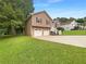 Split-level home with two-car garage, green lawn, and traditional curb appeal at 110 Silverthorne Dr, Douglasville, GA 30134